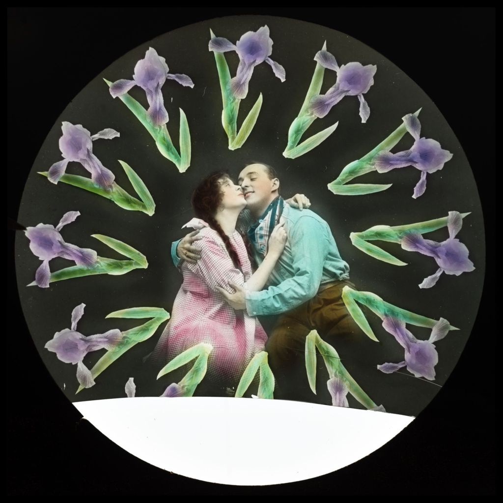 An unidentified couple embracing with purple irises encircling them