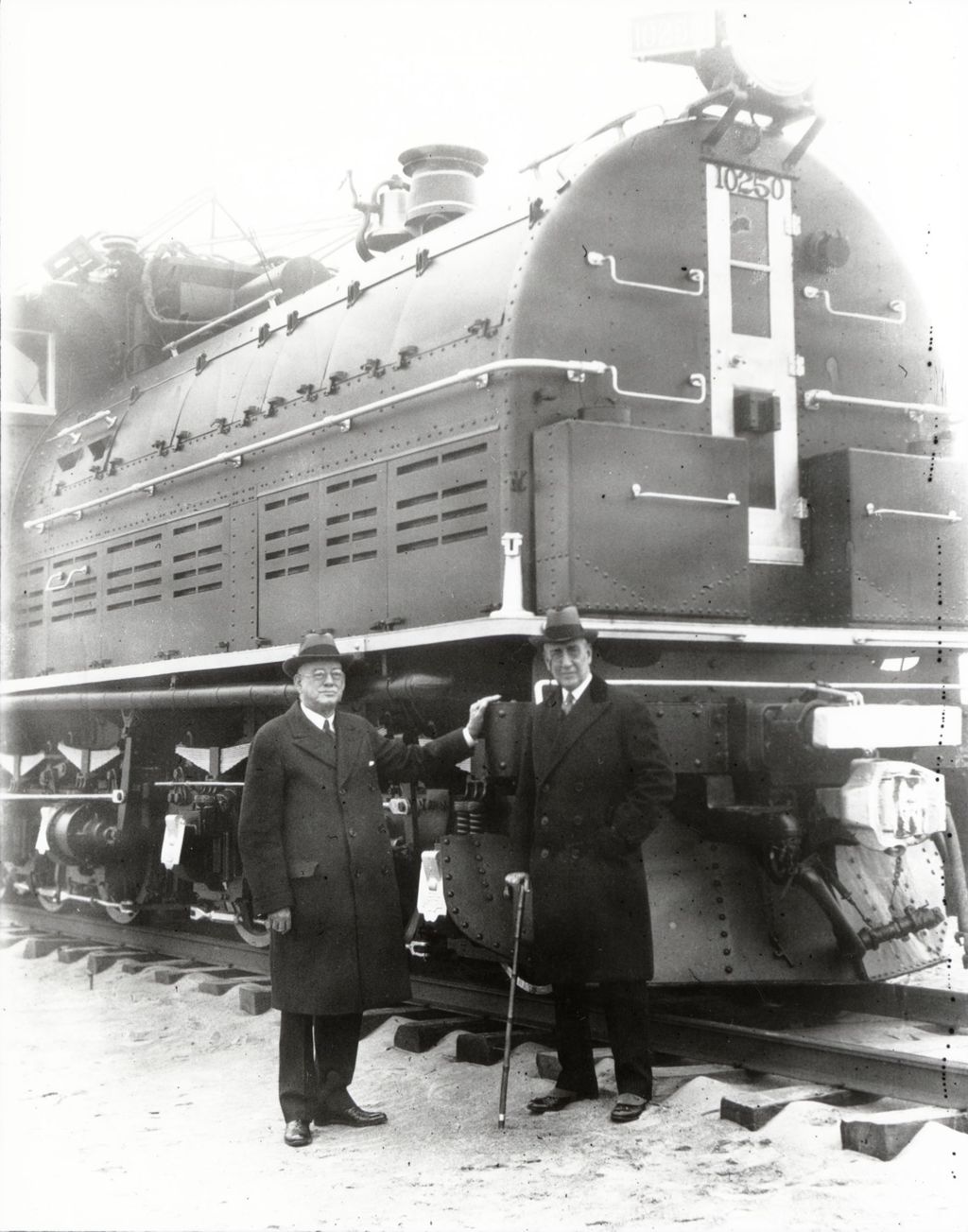 Rufus C. Dawes (right), president of the Century of Progress, in front of the Chicago, St. Paul & Milwaukee locomotive.