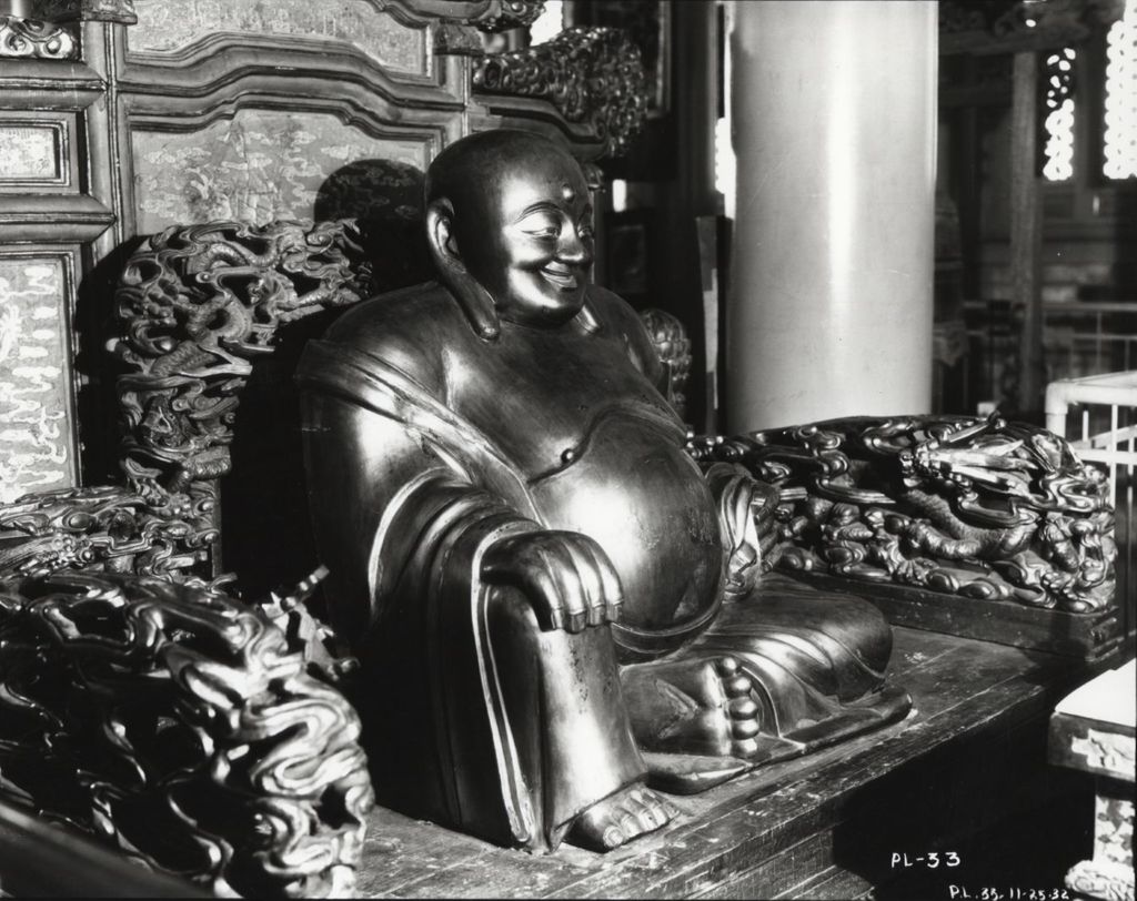Miniature of Laughing Buddha statue at the Lama Temple exhibit