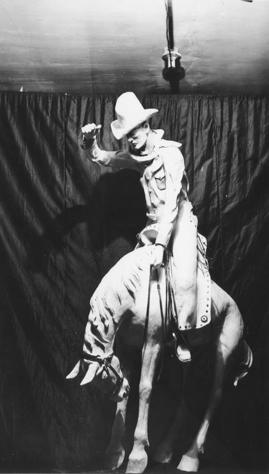 Miniature of Sculptor Wilber Freece created this small statuette of a cowboy riding a bucking bronco from beef suet and rinds.