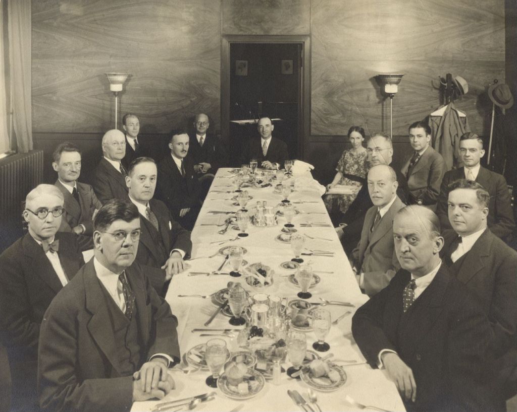 Miniature of Photo of general manager Lenox R. Lohr dining with other invited guests at a luncheon. Lohr is seated at the far end of the table in the center.