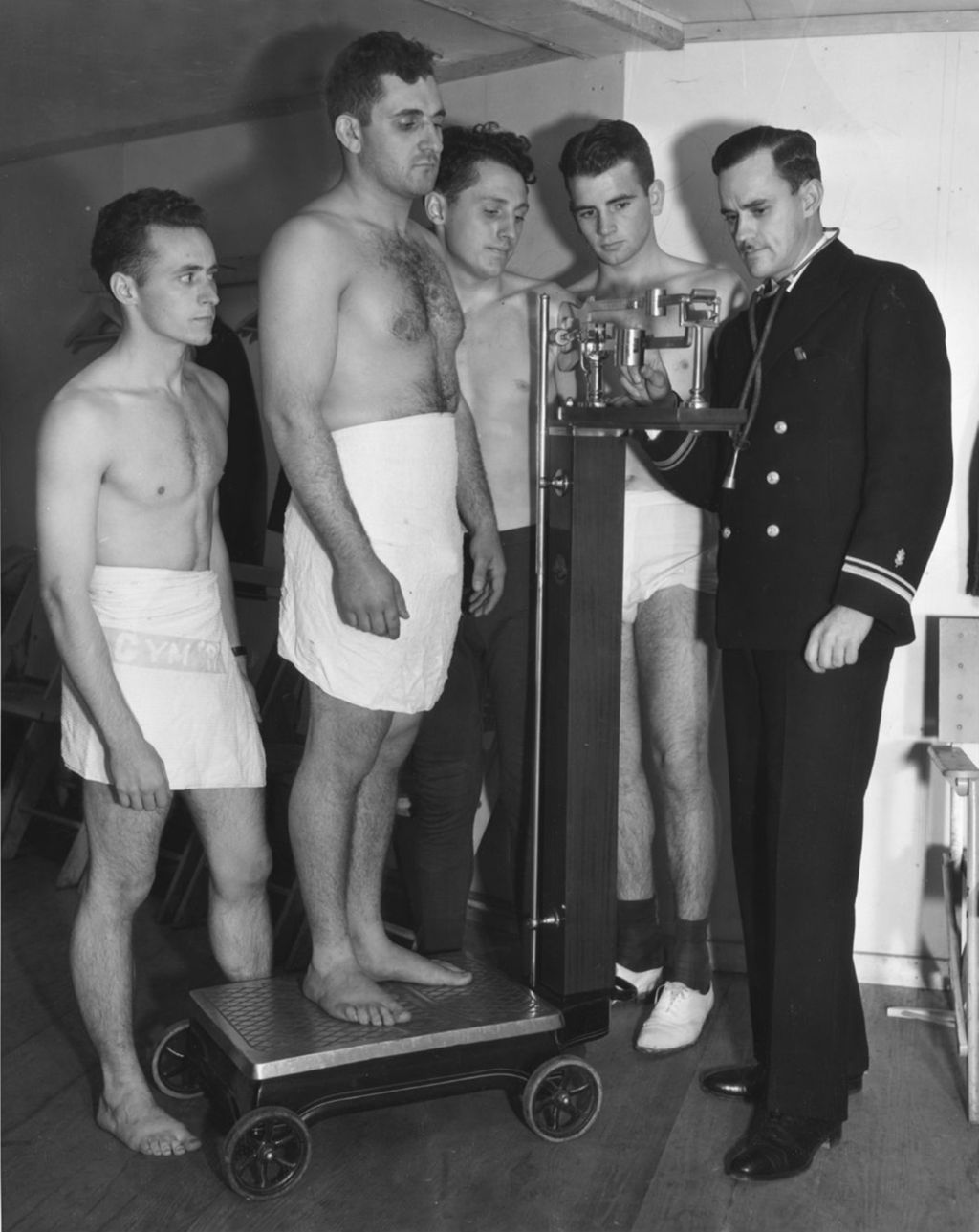 Miniature of University wrestlers examined by medical officer of the United States Navy.