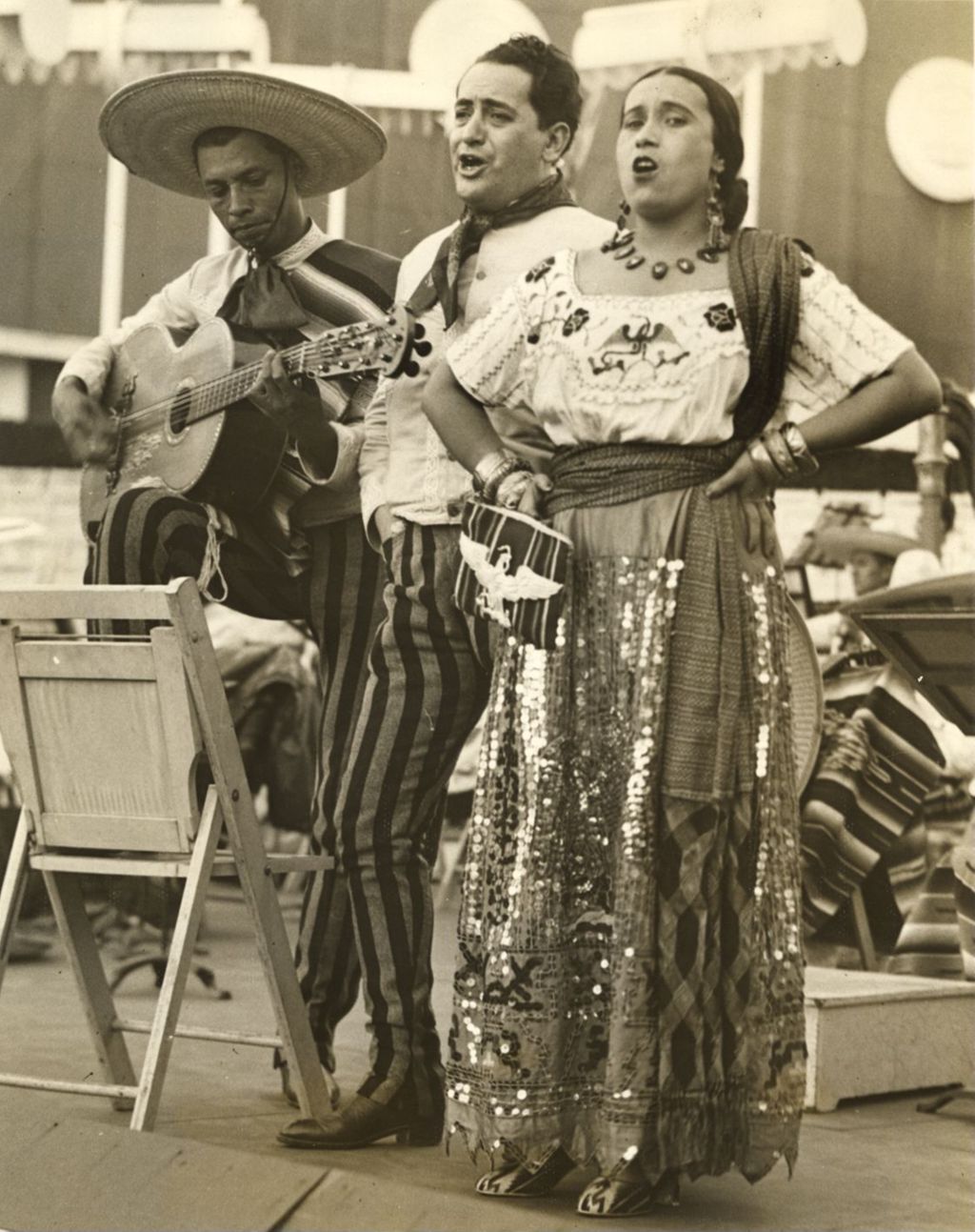 Three stars of the Tipica Police Orchestra of Mexico City performing in the Court of States