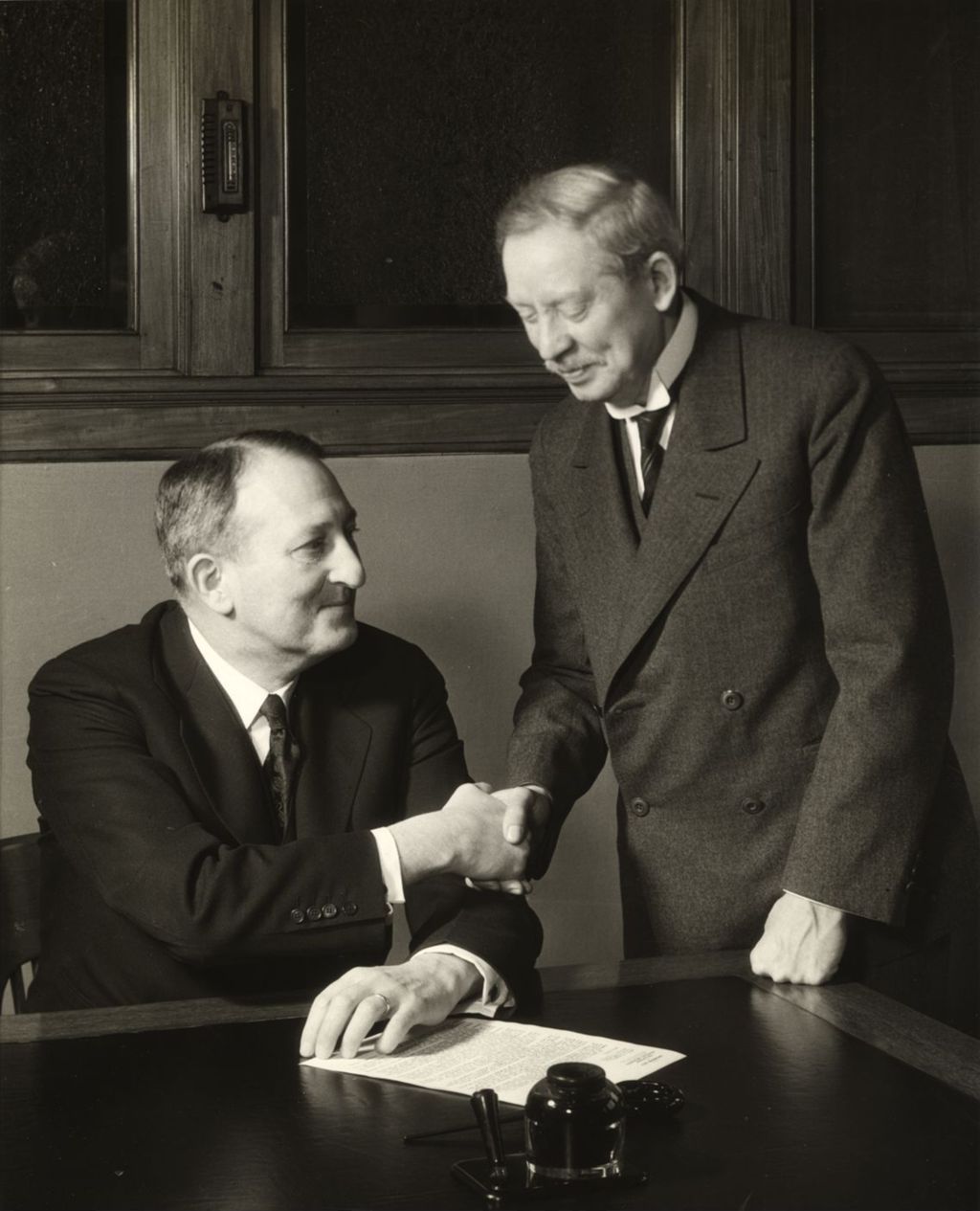 Miniature of G.F. Swift, President of Swift and Company signing a contract with Dr. Frederick A. Stock, conductor of the Chicago Symphony Orchestra
