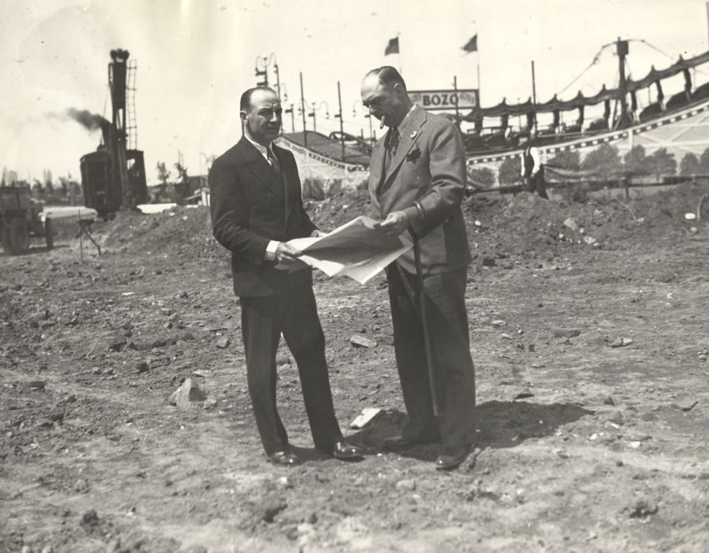 Miniature of Two men standing on the construction site where the Sky Ride was to be built for the Century of Progress International Exposition.