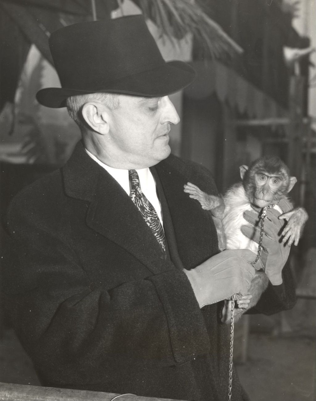 Miniature of A monkey from the Frank Buck Jungle Camp to be given as a door prize with T.A. Loveland, manager of the Jungle Camp