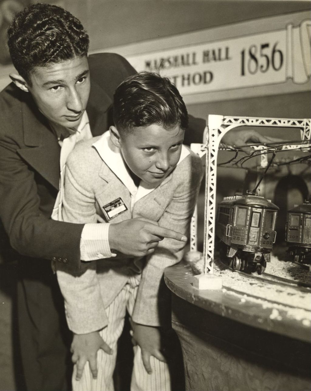 Miniature of Boys examining the Rapid Transit exhibit in the Hall of Science