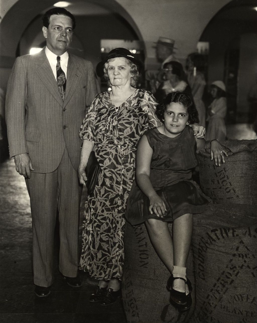 Photograph shows three generations of Cubans during a neighborly visit to the Puerto Rican exhibit