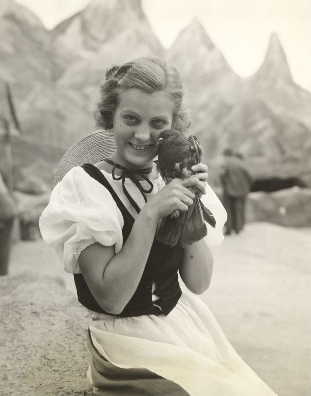 Miniature of Louise Grau holding homing pigeon
