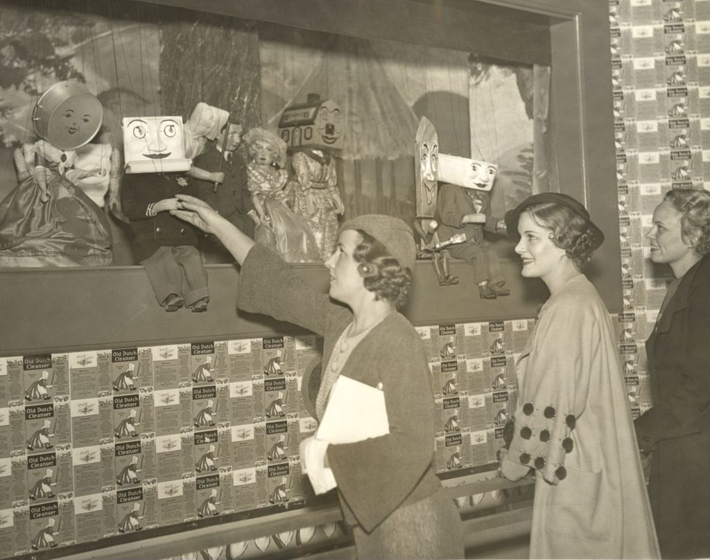 Three women visit the Pasadena Puppeteers in the Home Planning Hall at the World's Fair