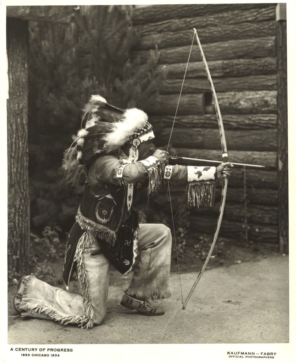 American Indian demonstrating the use of a bow and arrow at the Indian Village