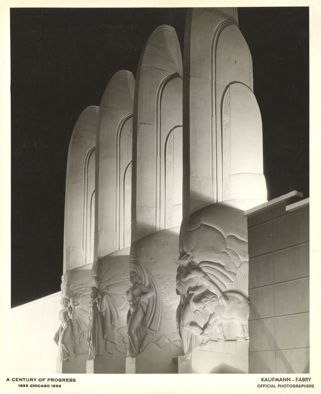 Miniature of Night time view of four pylon sculptures that decorate the north side of the Century of Progress Hall of Social Science.