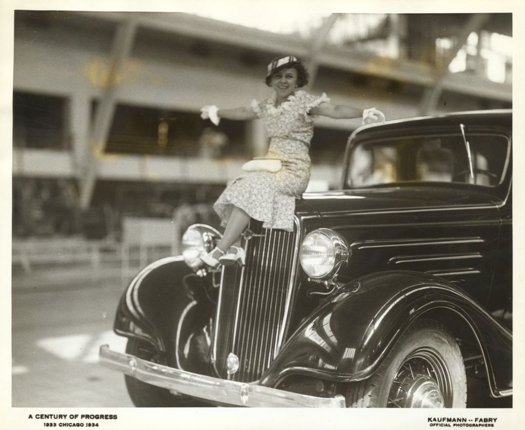 Young woman sitting on hood of a 1934 Chevrolet