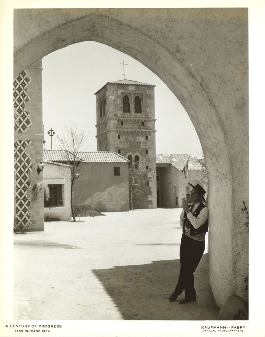 Man in costume standing underneath an archway at the Century of Progress Spanish Village.