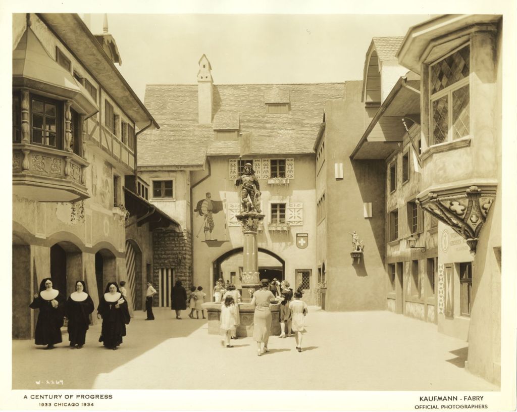 Miniature of Patrons walk through the Swiss Village at the Century of Progress Foreign Villages exhibition. Three nuns are waking to the left.