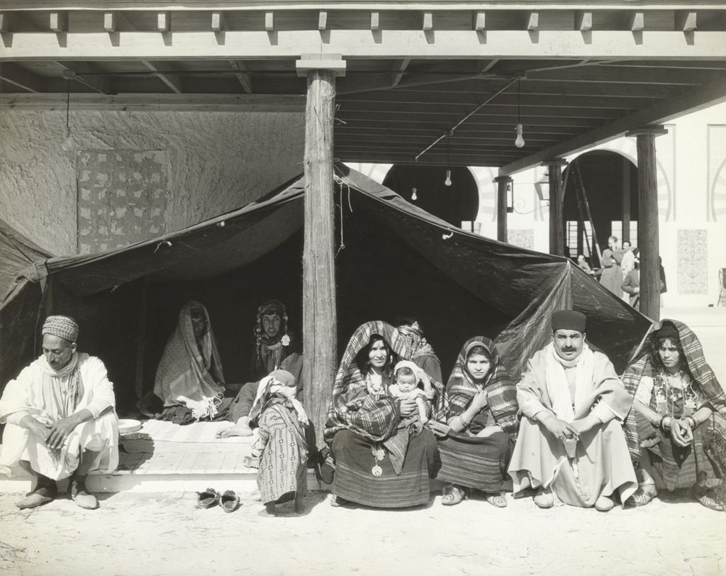 Miniature of Bedouin family sitting underneath a tent at the Foreign Villages exhibit