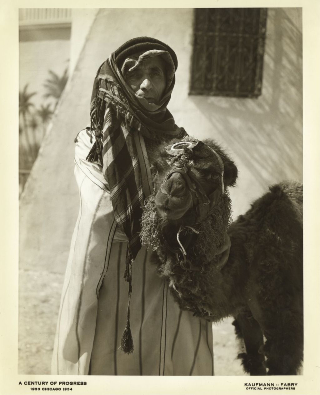 Man in Bedouin clothes next to camel at the Moroccan Village