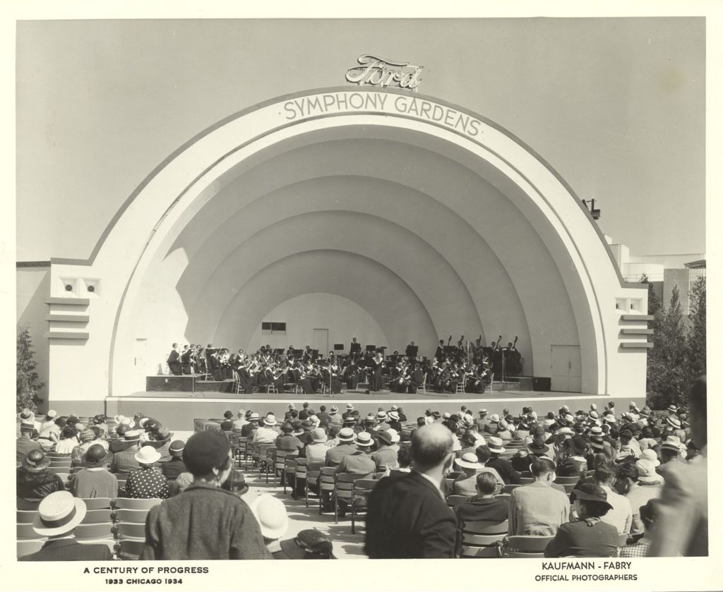 Audience view of an orchestral performance at Ford's Symphony Gardens bandshell