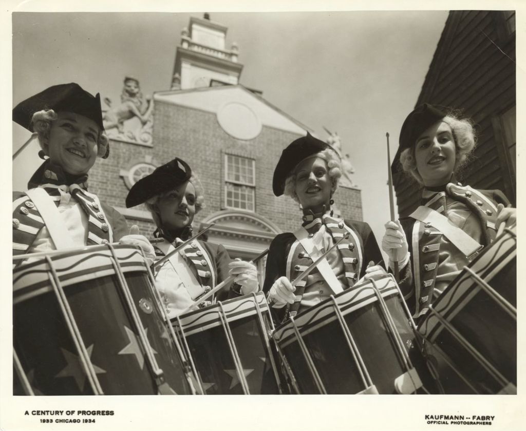 Miniature of Women in colonial American military costumes drumming in Colonial Village