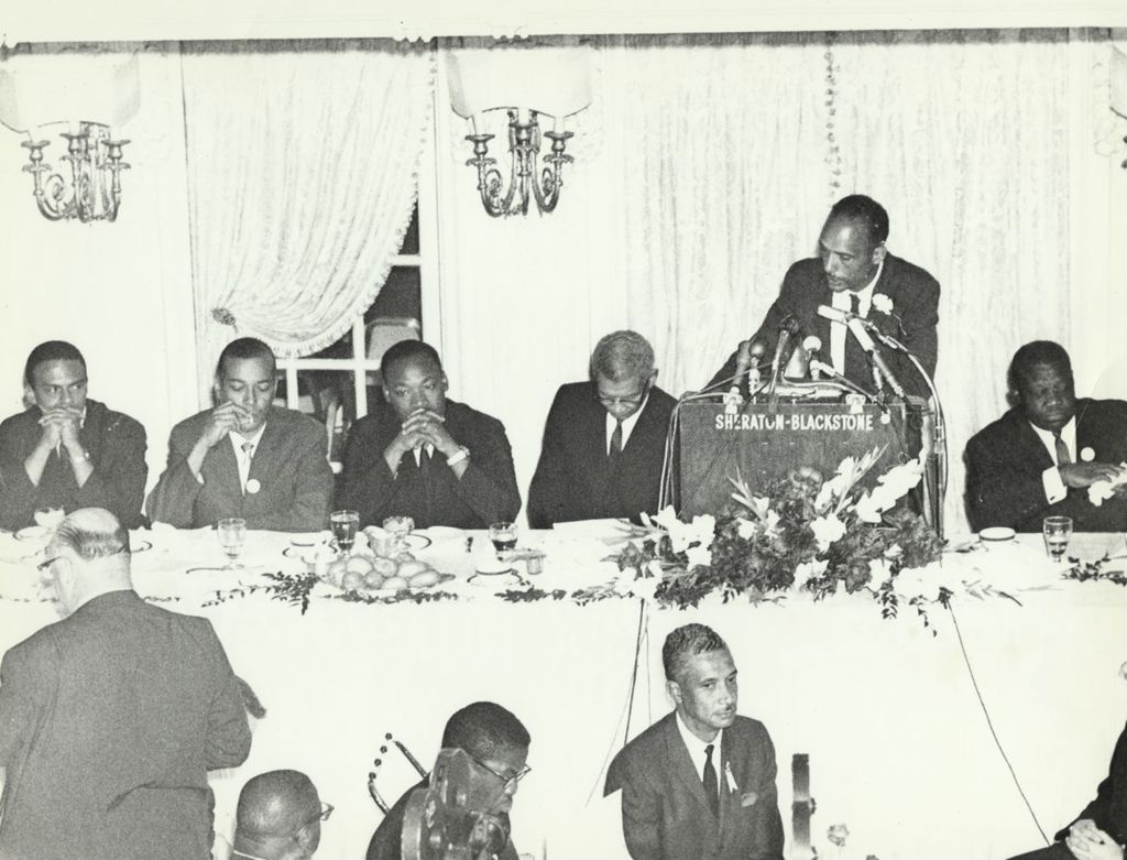 Miniature of Al Raby speaks at a dinner event