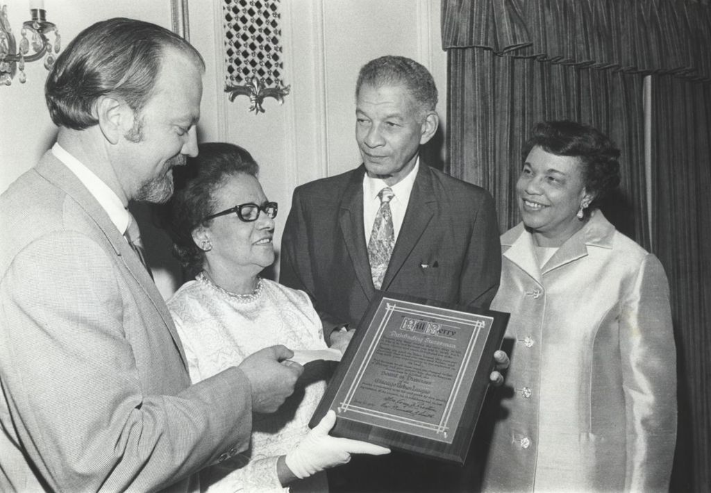 Bill Berry receives a plaque from the Chicago Urban League
