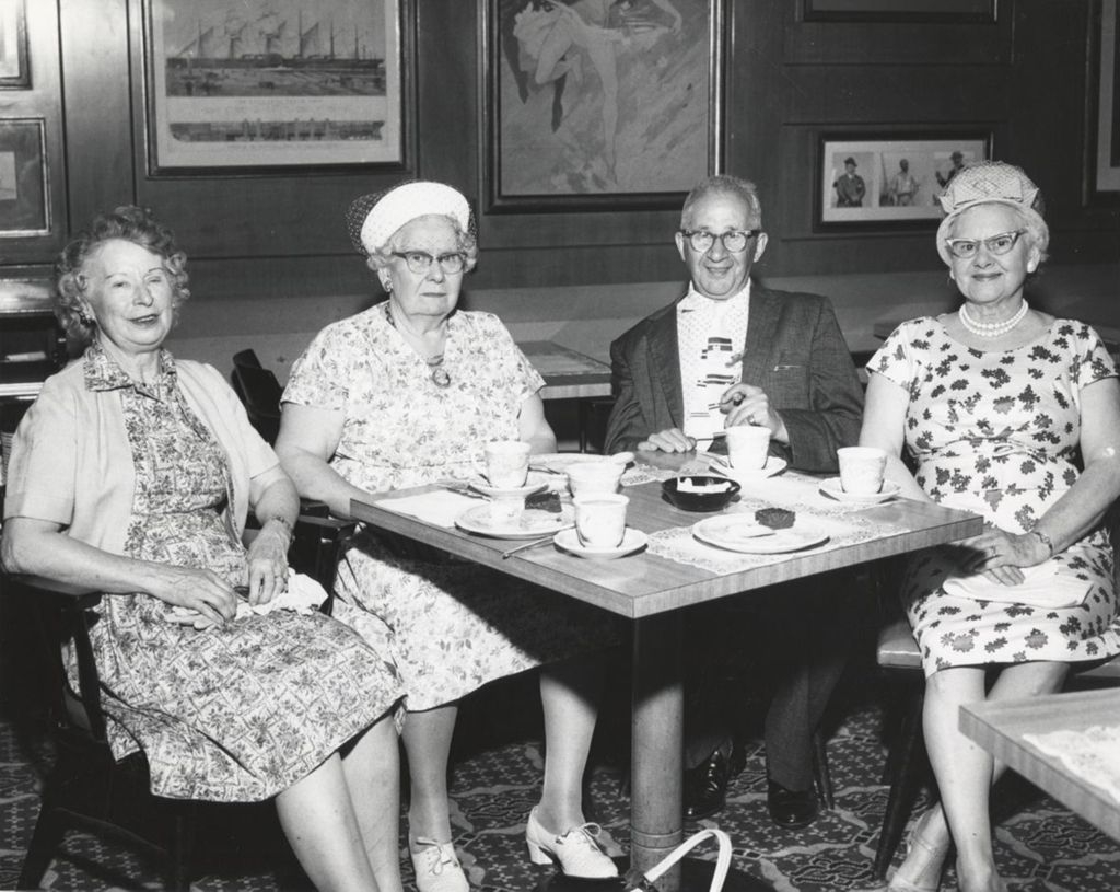 Miniature of Four seniors sitting at a table at an event