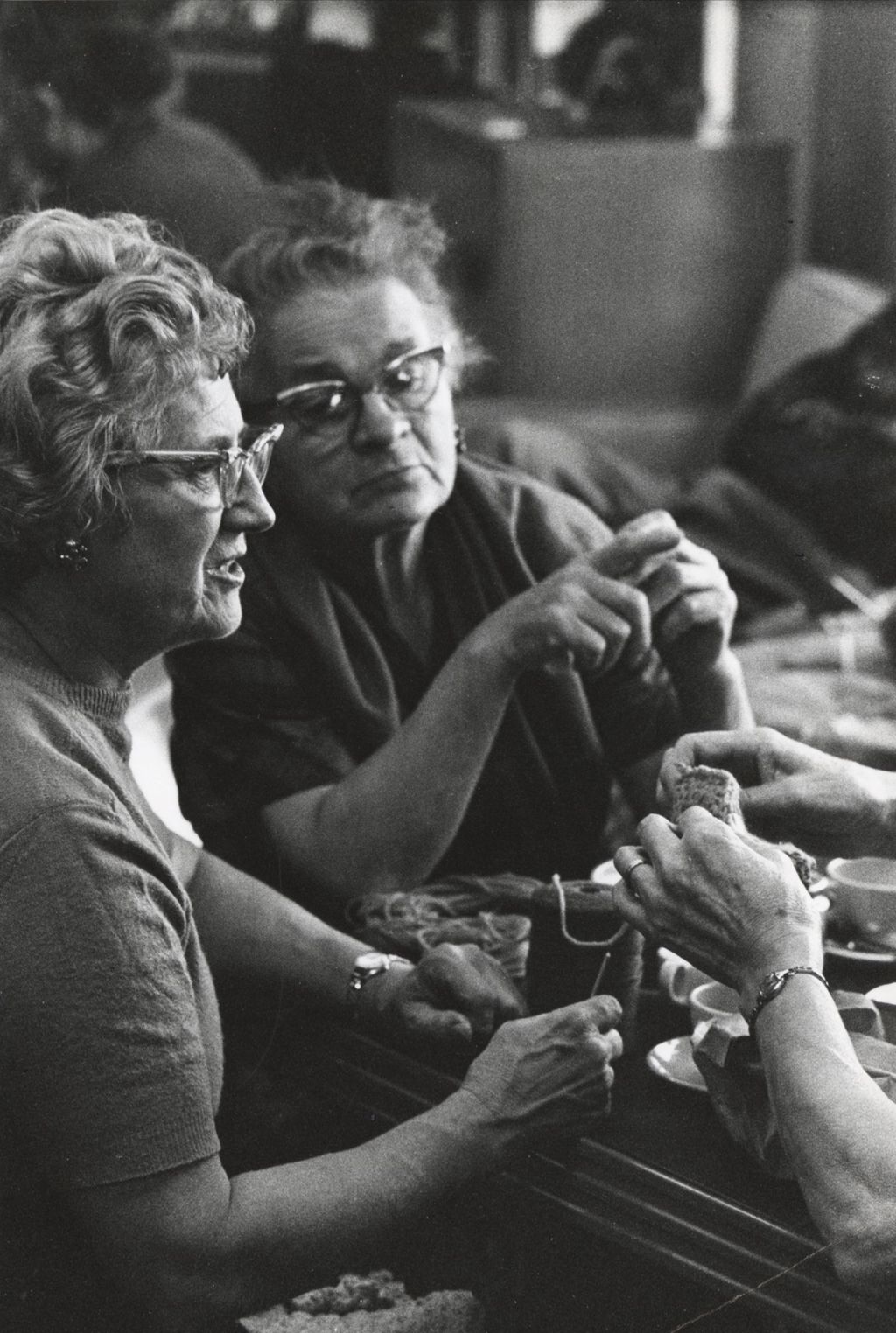Miniature of Women at a table with knitting supplies at a senior center