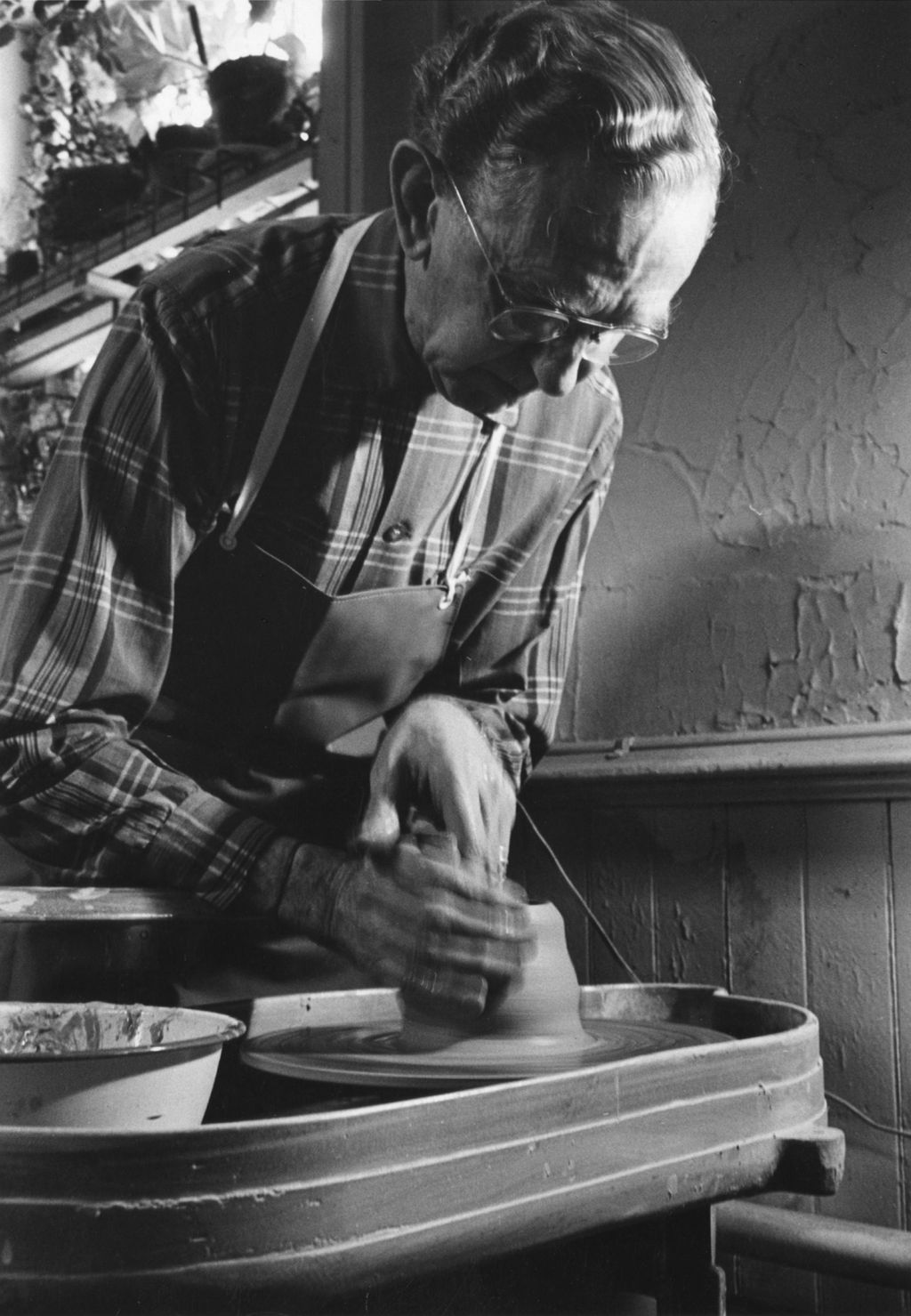 Senior man working at a ceramics wheel