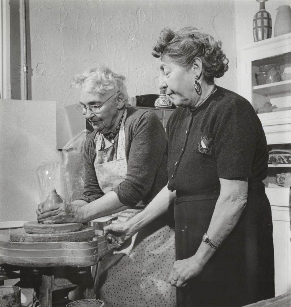Two senior women, Esther Szold and Marie Lane, at a ceramics wheel at the Mary Pomeroy Green Center