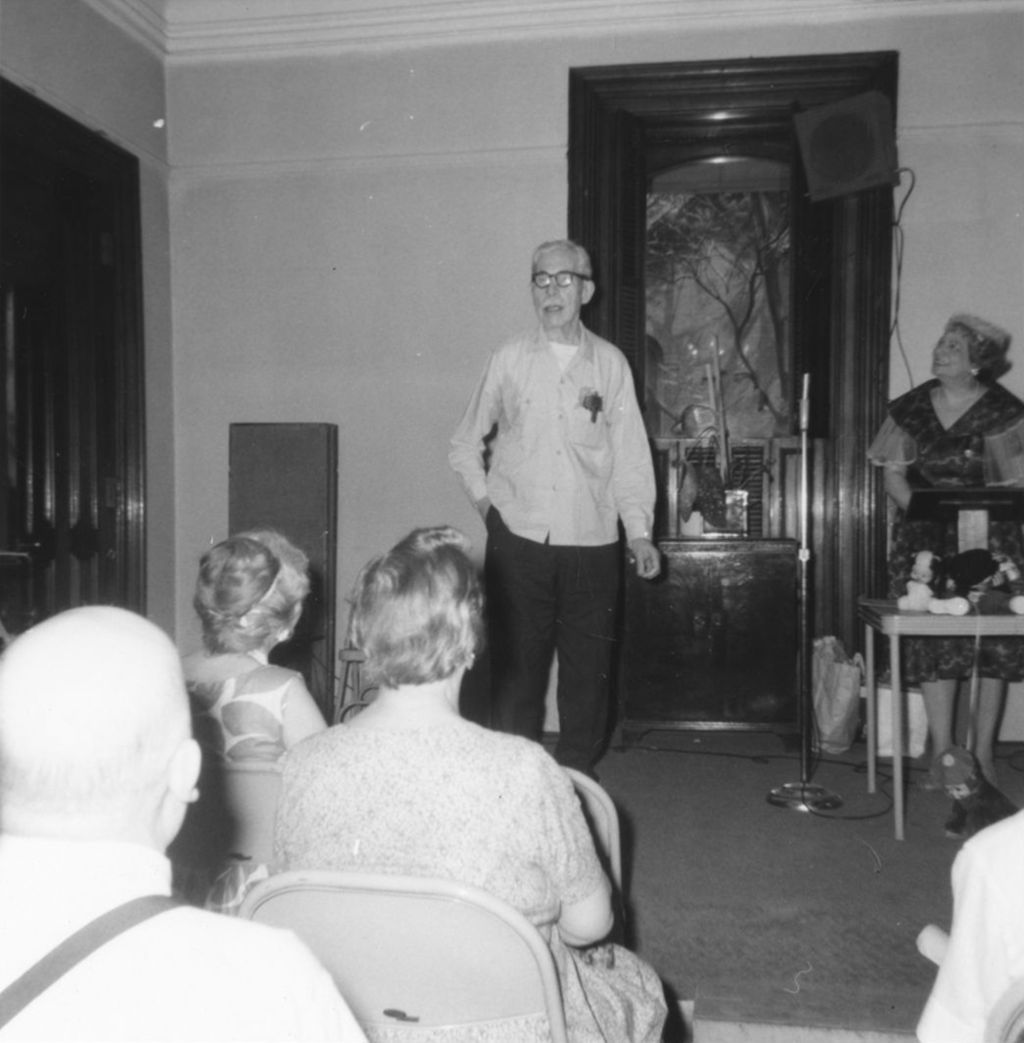 Man addressing an audience at an event at Hull-House or at a senior center affiliated with Hull-House