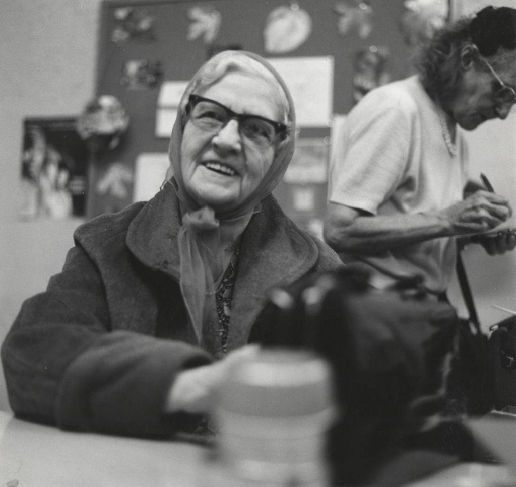 Senior woman wearing a jacket and head scarf at a senior center affiliated with Hull-House