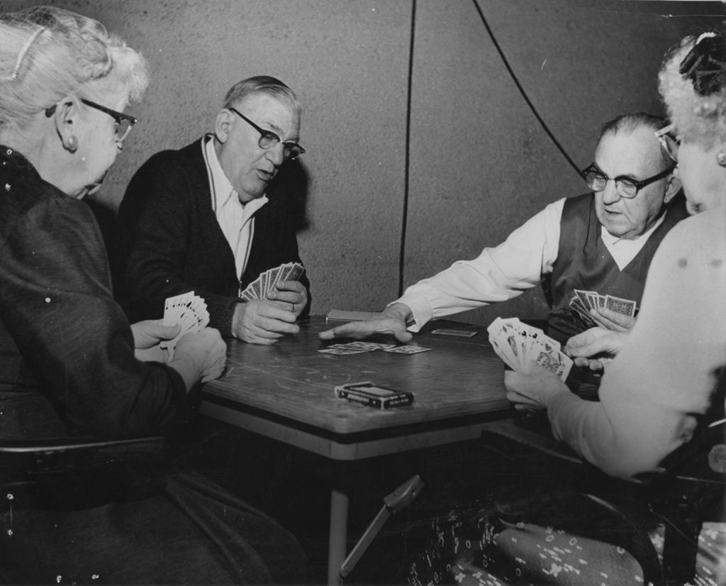 Four seniors playing cards at a senior center affiliated with Hull-House