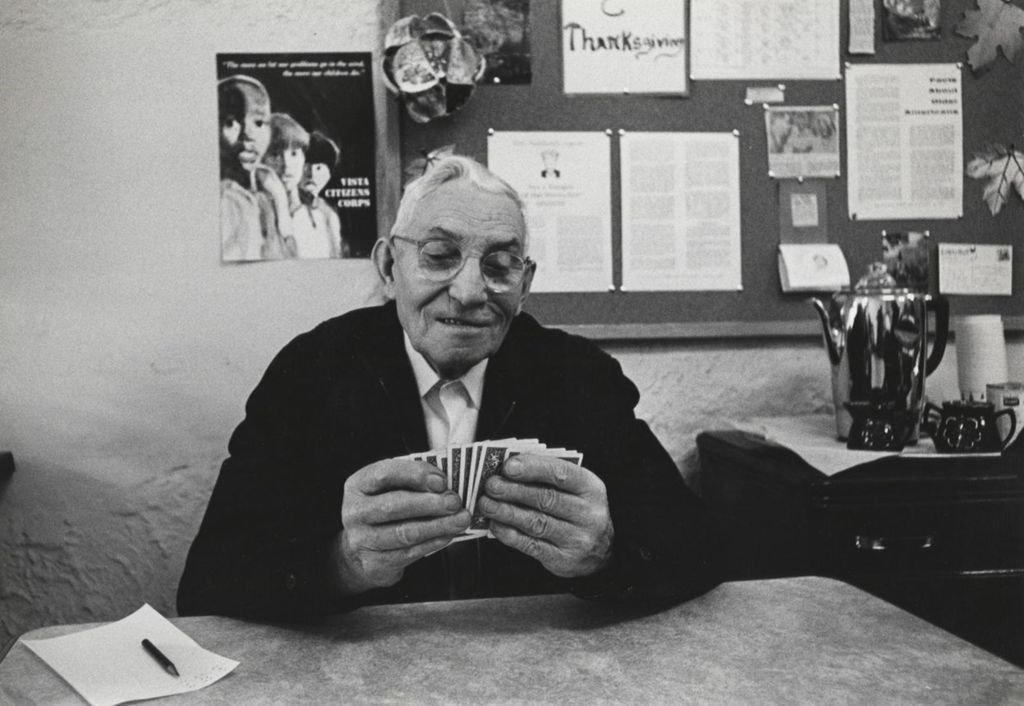 Man playing cards at a senior center affiliated with Hull-House
