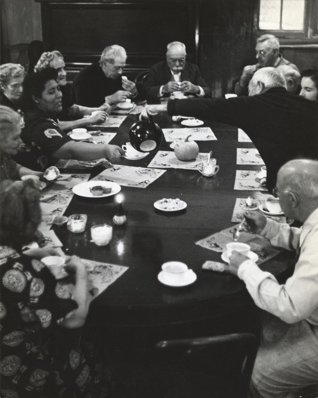 Members of the Hull-House senior citizens club having coffee or tea and cupcakes in the Residents Dining Hall