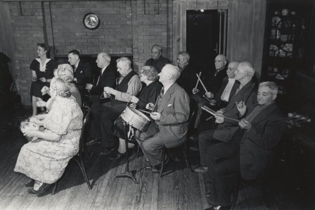 Members of the Hull-House senior citizens club playing instruments in a band during Carnival in the Residents Dining Hall