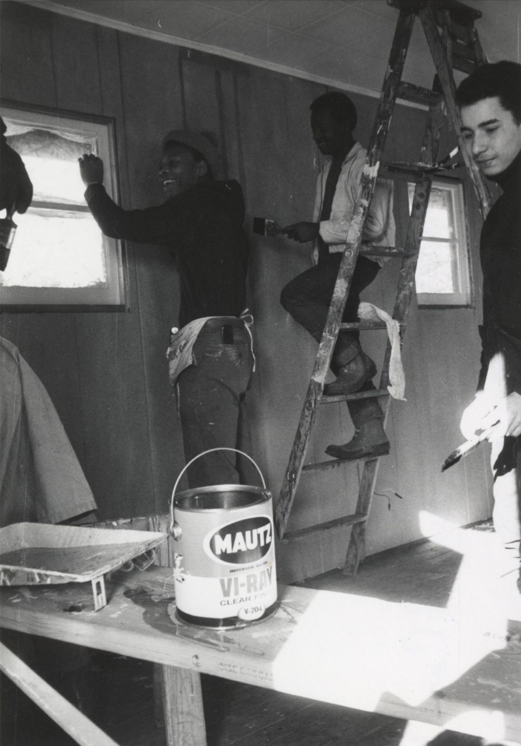 Young men doing construction work in a room at the Hull-House camp in Wisconsin