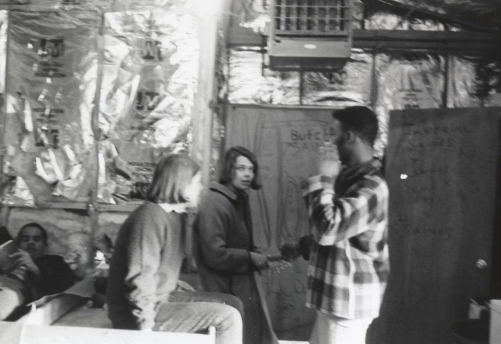 Young man talking with two other young people at the Hull-House camp in Wisconsin