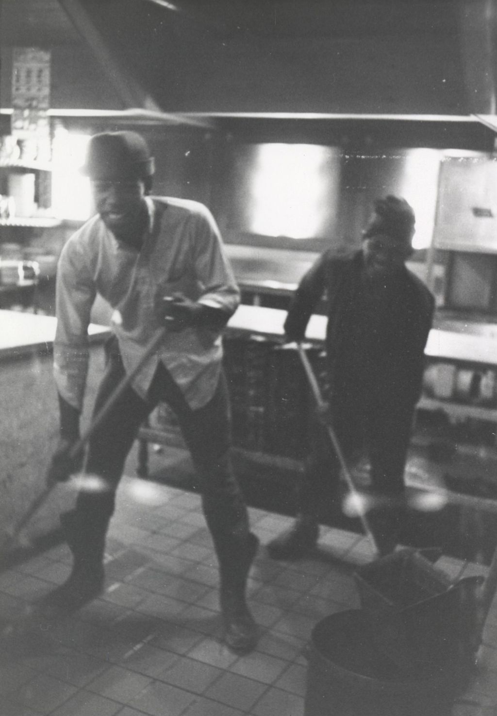 Young men mopping in the kitchen at the Hull-House camp in Wisconsin