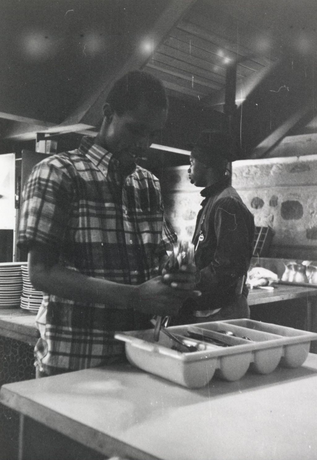 Two young men working in the kitchen at the Hull-House camp in Wisconsin