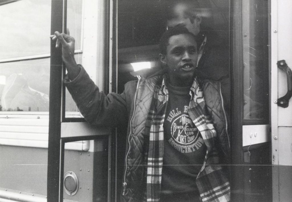 Young man in the doorway of a bus at the Hull-House camp in Wisconsin