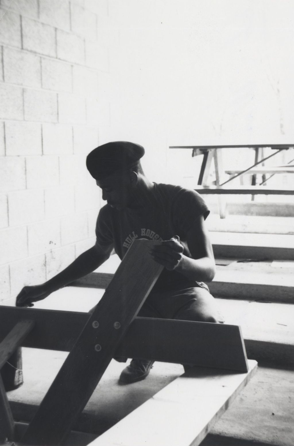 Young man working on a wood structure at the Hull-House camp in Wisconsin