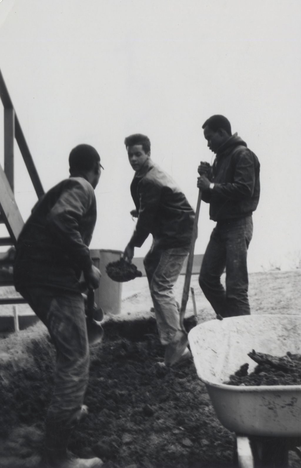 Young men digging into the ground at the Hull-House camp in Wisconsin