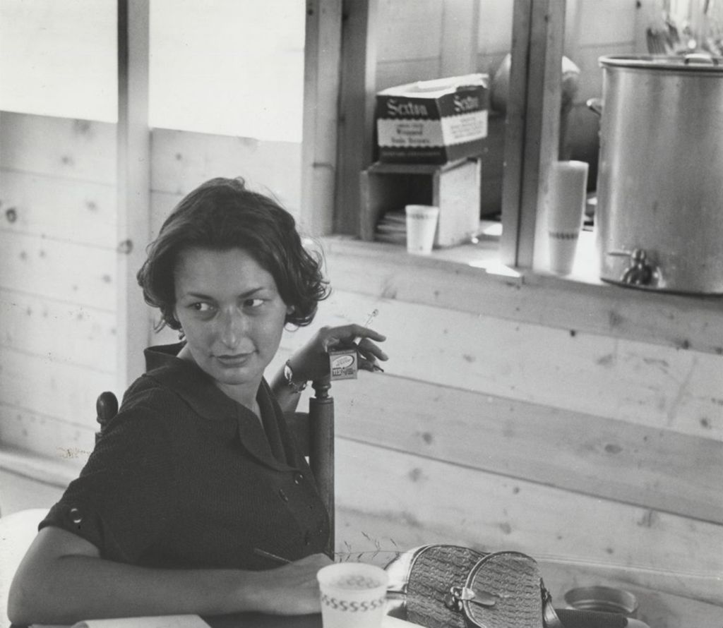 Woman sitting at a table at the Hull-House work camp in Wisconsin