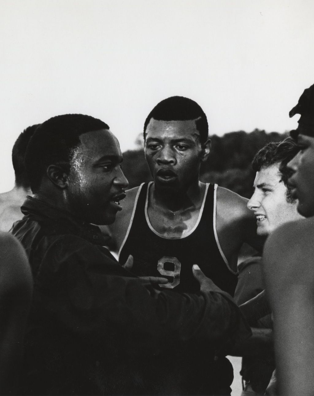Young men in a huddle at the Hull-House work camp in Wisconsin