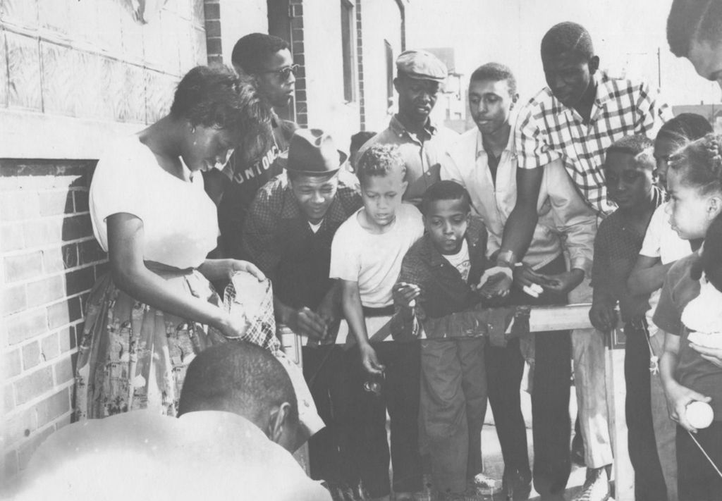 Young people playing a tossing game during Carnival Day, part of Parkway Community House's 1961 "Clean Up Week"