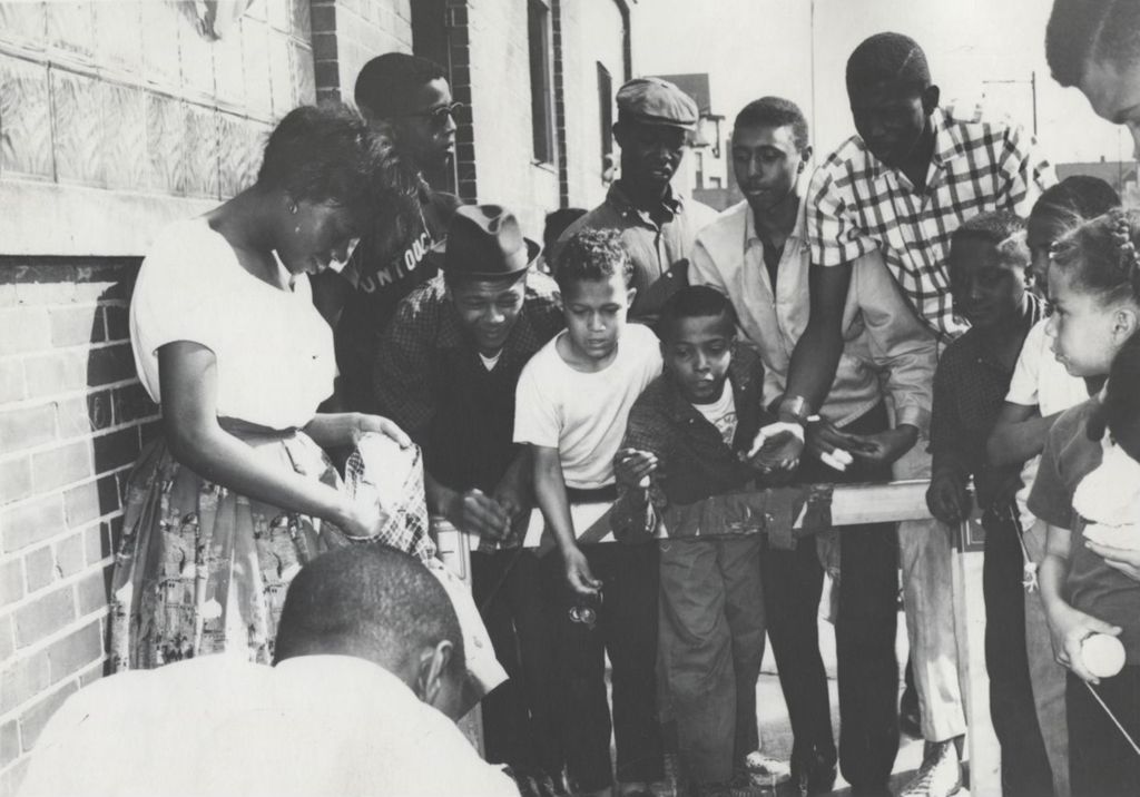 Miniature of Young people playing a tossing game during Carnival Day, part of Parkway Community House's 1961 "Clean Up Week"