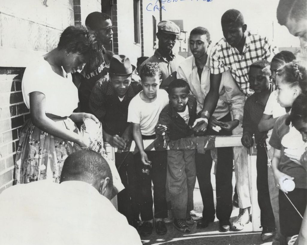 Miniature of Young people playing a tossing game during Carnival Day, part of Parkway Community House's 1961 "Clean Up Week"