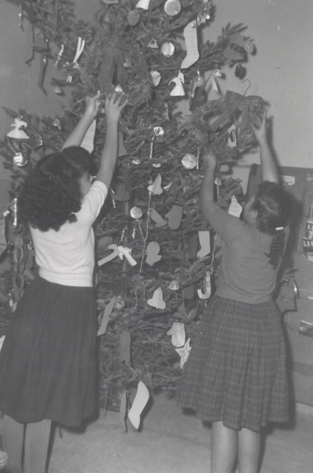 Two girls decorating a Christmas tree at Parkway Community House