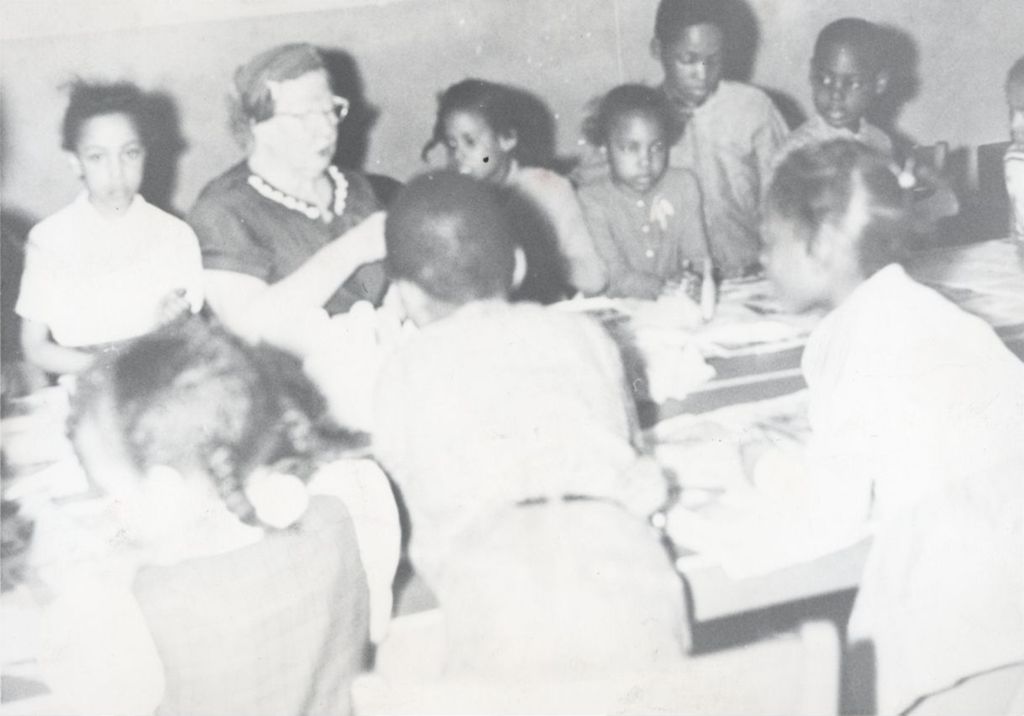 Miniature of Children and an adult instructor sitting at a long table at Parkway Community House