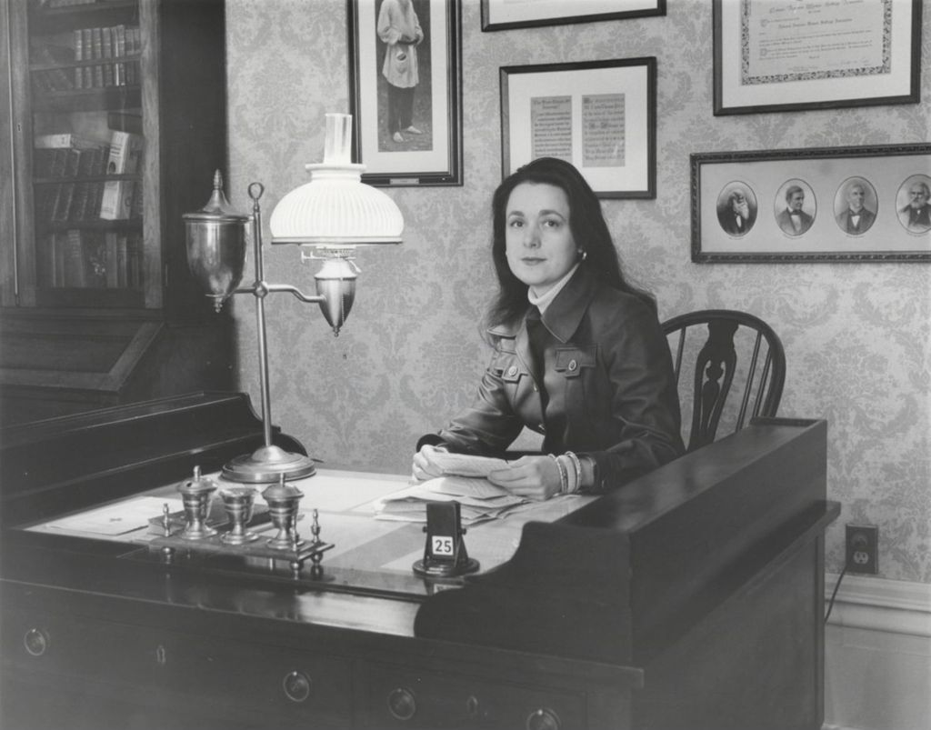 Mary Lynn McCree (Bryan), curator of Jane Addams Hull-House museum, seated at Jane Addams' desk